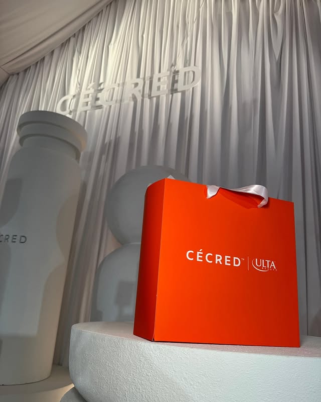 Ulta Beauty CÉCRED gift bag on display, featuring premium haircare products at an elegant branded event.